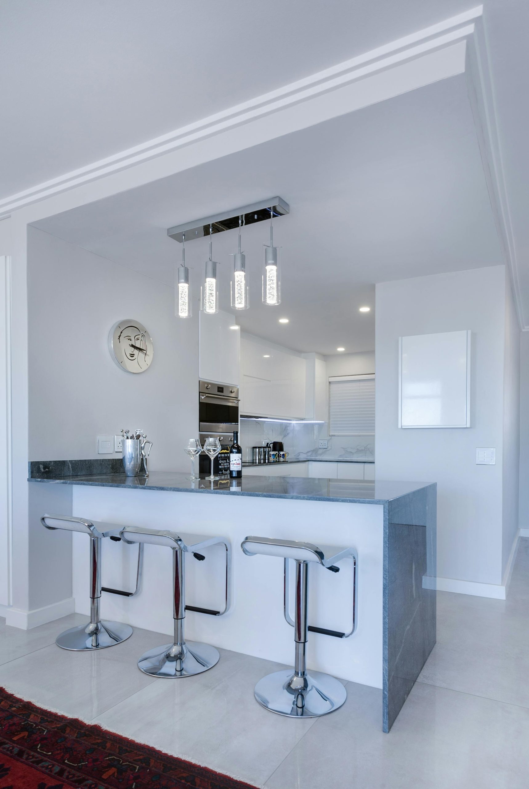 Bright kitchen showcasing a large island complemented by stylish bar stools.